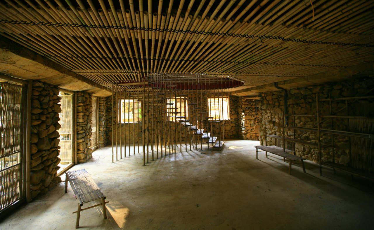 Suoi Re Village Community House among green rural landscape
